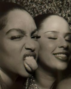 two women with their mouths open and tongue out