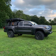 the truck is parked on the grass in the field