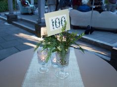 two vases filled with flowers on top of a table next to a sign that says mom