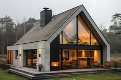 a modern house with an open floor plan and glass walls on the front porch area