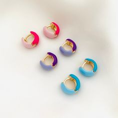 A pair of cute and colorful enamel chunky hoops. These two-tone huggie hoops are perfect for the summer and to give your outfit an extra pop of color. Please keep in mind the diameter of these huggies as they are fairly small and might not fit all earlobes! ⭐️Item Description: Size: 13 x 6mm Diameter: 7mm Benefits: Water & Tarnish Resistant, Hypoallergenic ⭐️About Our Earrings: Our earring collection ranges in styles to choose from. It contains the perfect earrings to complement and highlight th Enamel Hoop Earrings, Enamel Huggie Earrings Perfect For Gifts, Trendy Hypoallergenic Enamel Earrings, Trendy Multicolor Enamel Earrings, Trendy Pink Enamel Earrings, Multicolor Huggie Hoop Earrings For Gift, Multicolor Huggie Hoop Earrings, Trendy Enamel Earrings For Everyday, Pink Enamel Hoop Earrings