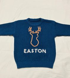 a blue sweater with the word easton written on it and a deer's head