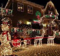 christmas lights decorate houses and lawns with snowmen, reindeers and santa clause