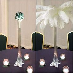 there are two tall vases with candles in them on top of the table, and one is decorated with feathers