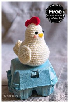 a crocheted chicken sitting on top of an egg carton with the words free written below it