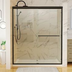 a white bathroom with marble walls and floor