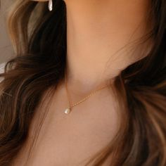 Featuring a delicate pearl and classic gold chain, this timeless piece adds a bit of romantic charm to your look. It's the perfect necklace to make your day just a little more special! DETAILSOffered in 14", 16", or 18" lengths, Gemstone measures at 0.25"Available in 14k Gold Fill and Sterling SilverHypoallergenic and nickel freeWe recommend removing pearls before showering, swimming or sleeping to keep them shining bright Classic Gold Charm Necklace With Pearl Drop, Feminine Pearl Charm Necklaces For Anniversary, Everyday Gold Feminine Pearl Necklace, Gold Pearl Necklace For Everyday Feminine Style, Feminine Everyday Gold Pearl Necklace, Everyday Feminine Gold Pearl Necklace, Feminine Pearl Necklace With Delicate Chain, Classic Gold Charm Necklace With Pearl Chain, Classic Gold Pearl Chain Charm Necklaces