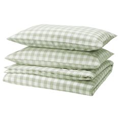 three pillows stacked on top of each other in green and white gingham checks