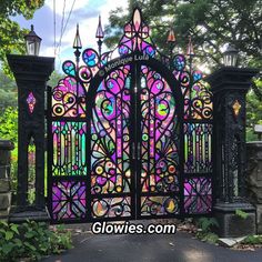 an iron gate with colorful stained glass in the front and side panels on each side