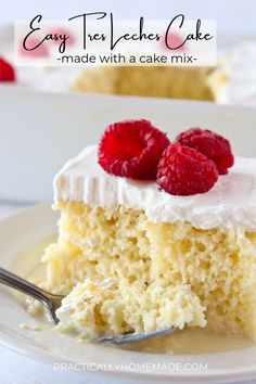 a slice of tres leches cake with white frosting and raspberries on top