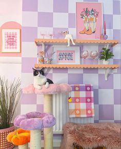 a black and white cat sitting on top of a scratching post in a living room