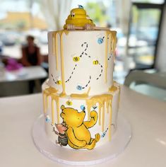 a winnie the pooh cake with honey dripping on it