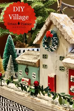 a christmas village made out of wooden houses and wreaths on top of each other