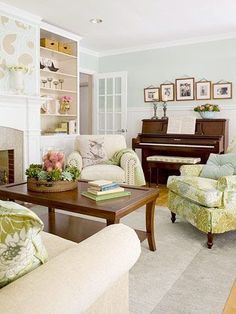 a living room filled with furniture and a piano