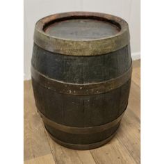 a wooden barrel sitting on top of a hard wood floor