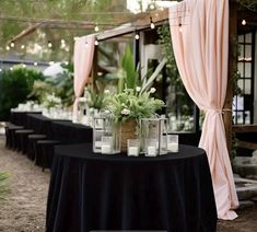 there are many vases with flowers on top of the table at this wedding reception