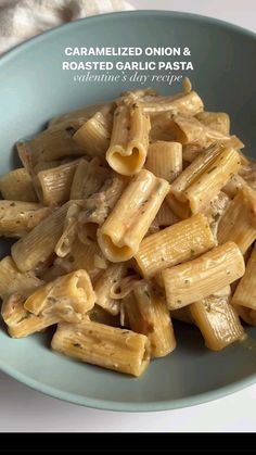 a blue bowl filled with pasta on top of a table