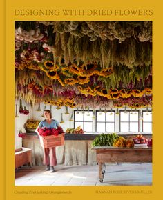 a woman standing in front of a table filled with fruits and vegetables on top of a yellow book cover