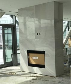 a large white fireplace sitting in the middle of a room