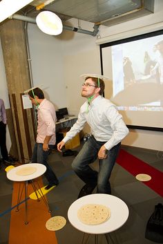 a man standing in front of a projector screen with food on it's legs