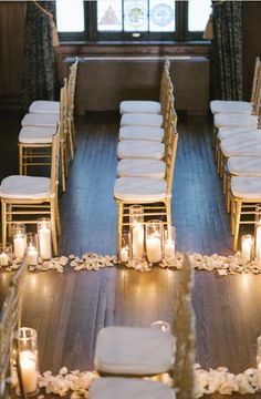 the ceremony room is set up with candles and white linens on the floor, along with rows of chairs