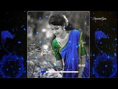 an image of a woman in blue and green sari with flowers on the background