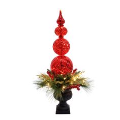 a red vase with christmas decorations and lights on it's sides, in front of a white background