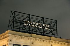 a sign on top of a building that says these words hold no power over you