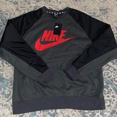 New Nike Graphic Hybrid Crew Neck Sweater Size: Xlarge Color: Grey Black Red Brand New With Tags Nike Crew Neck Sweatshirt For Outdoor, Black Crew Neck Sweatshirt For Outdoor, Nike Gray Sweatshirt For Streetwear, Nike Crew Neck Outerwear For Fall, Nike Gray Long Sleeve Sweatshirt, Nike Gray Tops For Fall, Nike Black Urban Sweatshirt, Nike Casual Outerwear With Crew Neck, Nike Gray Outerwear With Ribbed Cuffs