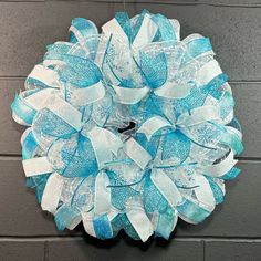 a blue and white wreath hanging on the wall