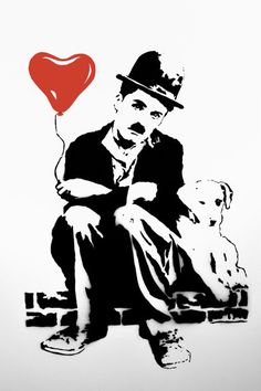 a man with a heart balloon sitting next to a dog