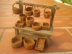 a wooden bench with baskets on it and some other items sitting on the ground in front of it