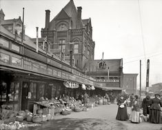 an old black and white photo of people shopping