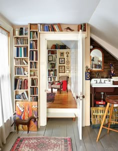 the room is filled with books and furniture