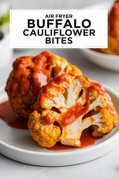 two pieces of roasted cauliflower on a white plate with the words air fryer buffalo cauliflower bites