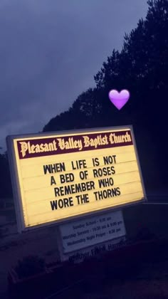 a sign that has been placed in front of a church with a heart on it