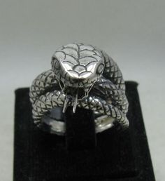 Sterling silver ring 925/1000, huge snake. Stamped 925. Approximate weight 19.4 grams. Width 1.8cm. All our jewels are made from solid sterling silver 925/1000 and are carefully crafted by hand in our family workshop. We dispatch your orders in 5 working days, worldwide and the postage is $5. We ship registered priority mail. Please allow 5-7 working days for delivery in Europe and 10-15 working days outside Europe. For any questions - please do not hesitate to contact me! Sterling Silver Snake-shaped Rings, Silver Engraved Snake Ring Collectible, Unique Sterling Silver Snake Ring, Silver Snake-shaped Ring For Formal Occasions, Engraved Silver Snake Ring Collectible, Silver Snake Ring For Formal Occasions, Unique Silver Snake Ring For Anniversary, Unique Sterling Silver Snake Ring For Formal Occasions, Elegant Silver Snake Ring For Collectors