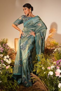 Teal green and blue saree with bloom applique and Swarovski embellishments. Paired with a boat neck applique work embellished elbow sleeves blouse. - Aza Fashions Festive Green Pre-draped Saree With Floral Embroidery, Green Pre-draped Saree With Floral Embroidery, Green Floral Embroidered Saree For Reception, Designer Green Pre-draped Saree With Floral Embroidery, Designer Green Tissue Silk Blouse Piece, Green Tissue Silk Blouse With Dupatta, Designer Green Tissue Silk Blouse, Green Organza Blouse With Resham Embroidery, Festive Green Saree With Floral Embroidery