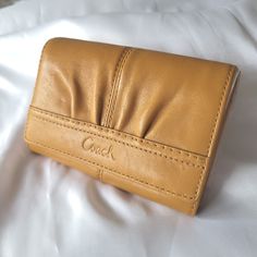 Coach Soho Saffron Pleated Leather Coach Monogram Pattern Bi-Fold Clutch Wallet Nwt This Bi-Fold Is The Perfect Wallet For A Smaller Crossbody Or Shoulder Bag. It's Fall Ready. Features: *Several Slip Pockets Inside And Out For Ids & Credit Cards. *Main Zipper Compartment To Add More Cards Or Cash. *Side Cash Compartment *Unique Front Pleat *Genuine Leather With The Coach Monogram Pattern *Clutch Style With Quality Outer Seam Detail Style Tags: Functional, Everyday, Compact, Soho, High Quality, Durable. Measures: 5.5"W X 3.5" H X 1"Thick This Item Is Nwt. With A Price Tag Of $188.00, This Price Is A Great Deal! Full Disclosure: It Does Have A Few Marks From Being Stored That S Coach Gold Leather Wallet, Coach Monogram, Full Disclosure, Monogram Pattern, Leather Coach, Small Crossbody, It's Fall, Price Tag, Clutch Wallet