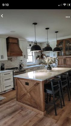 a large kitchen with an island in the middle and lots of stools around it