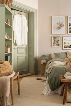 a bedroom with green walls and pictures on the wall