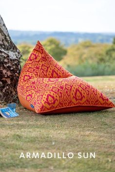 A  bright orange and pink patterned bean bag chair is say temptingly under a tree on a hillside. An open book lies next to it. Luxury Bean Bag Chairs, Wellbeing Space, Arabian Design, Gazebo Decor, Bean Bag Furniture, Gazebo Decorations, Luxurious Garden, Comfort Luxury