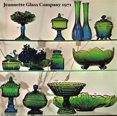 green glass vases and bowls displayed on shelves