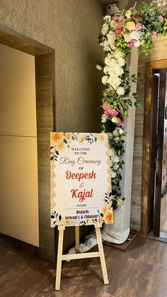 a sign in front of a doorway that says deepesh kaal with flowers on it