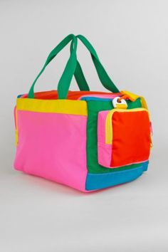 a multicolored tote bag sitting on top of a table