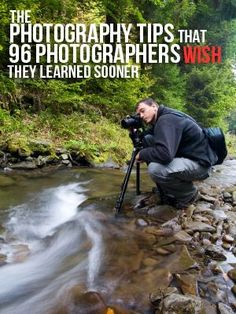 a man is taking pictures in the water with a camera and tripod on his knees