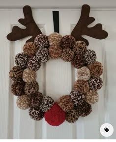 a christmas wreath made out of donuts with reindeer antlers on the front door