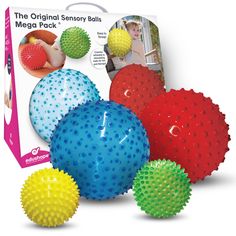 four different colored balls are in front of a box with an image of the original sensory balls