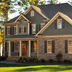 a large gray brick house with lots of windows