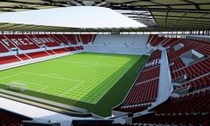 an artist's rendering of a soccer stadium with red seats and a green field